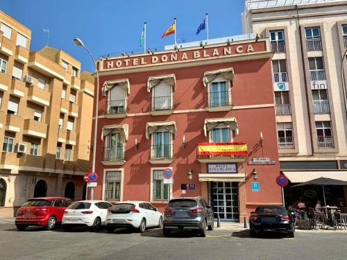 a building with cars parked in front of it at Hotel Doña Blanca in Seville