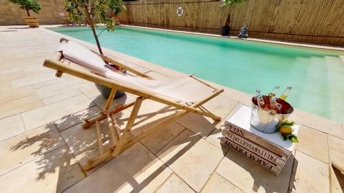 a lounge chair next to a swimming pool at Ron De Mar #2 modern room in Pezinok