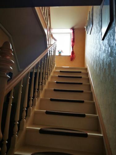 a stairway with white steps and a window at Ferienwohnung in einem alten Bauernhaus in Lontzen