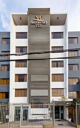 a building with a sign on the side of it at Hotel Médano in Trujillo