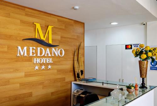 a melona hotel sign on the wall of a lobby at Hotel Médano in Trujillo