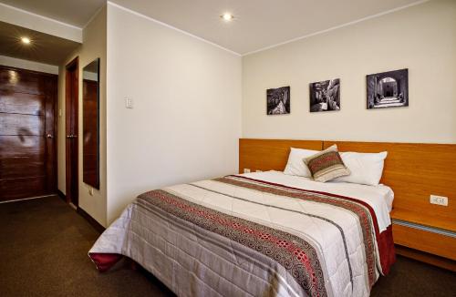 a bedroom with a large bed in a room at Hotel Médano in Trujillo