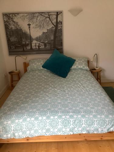 a bed with a blue comforter in a bedroom at Primrose Villa self catering bnb in Monmouth