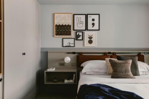 a bedroom with a bed, a desk and a lamp at Leven Manchester in Manchester