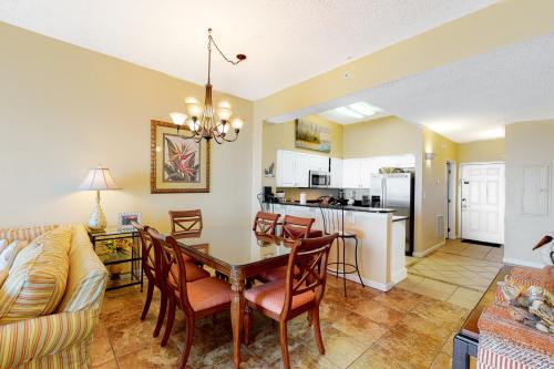 a dining room and living room with a table and chairs at Windemere Condominiums in Perdido Key