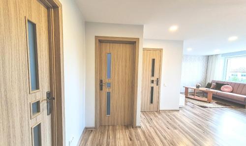 an empty living room with a door and a couch at Cozy 3 bedroom apartament in town centre of Joniškis in Joniškis