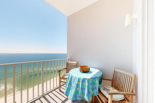 a table and chairs on a balcony with the ocean at Windemere Condominiums in Perdido Key