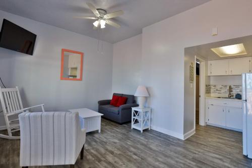 a living room with a couch and a chair at Coastal Waters in New Smyrna Beach