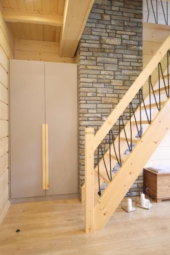 a room with a staircase and a brick wall at Apartamenty Augustynówka in Brzegi