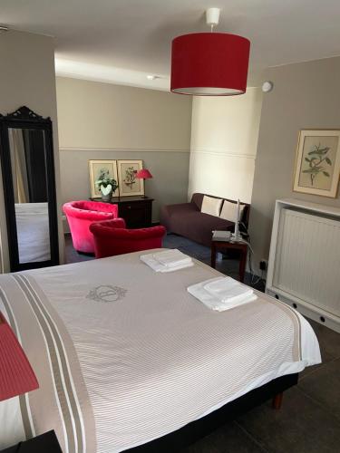 a bedroom with a large bed and a couch at Begijnhofstudio's in Tongeren