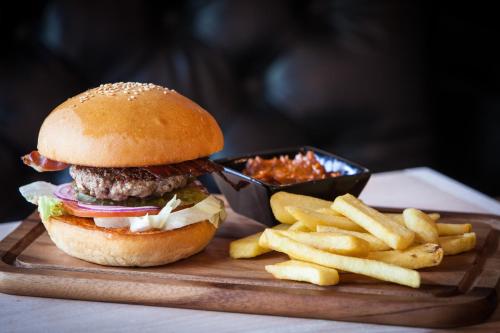 a hamburger and french fries on a wooden tray at Pointe Isabelle in Chamonix-Mont-Blanc