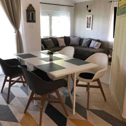 a dining room table and chairs in a living room at Panoráma Villa in Balatonboglár