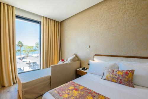 a hotel room with two beds and a window at Chic Boutique Hotel Vlore in Vlorë