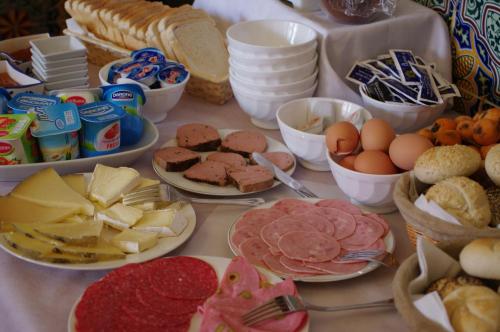 a table filled with different types of food on plates at Hotel Segles - Turismo de Interior in Campos