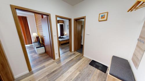 a hallway with a room with a bed and a mirror at Apartmán Tobias, PRIMO, Starý Smokovec in Vysoke Tatry - Stary Smokovec