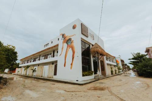 a building with a painting of a man on it at Hotel Boutique Naj Casa Holbox in Holbox Island