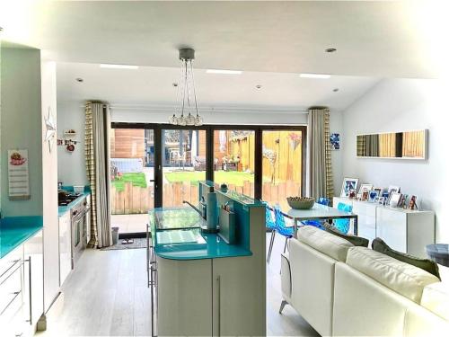 a kitchen with a blue island in a living room at 8 Guests House Wow in Coventry