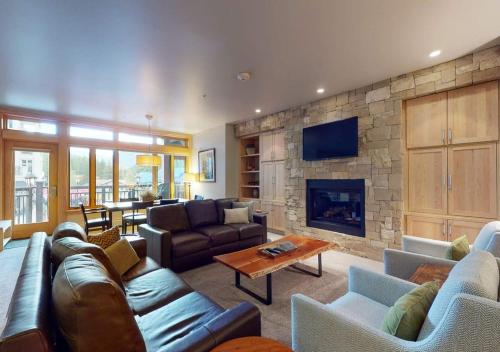 a living room with a couch and a fireplace at Lion Square Lodge Condos by TO in Vail