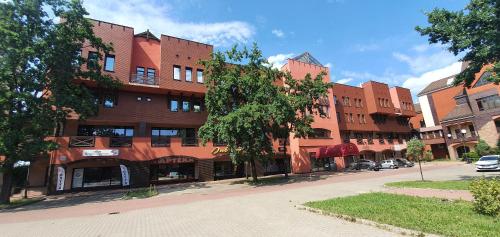 a large red brick building on a city street at Sieć Hoteli Fort Warszawa in Warsaw