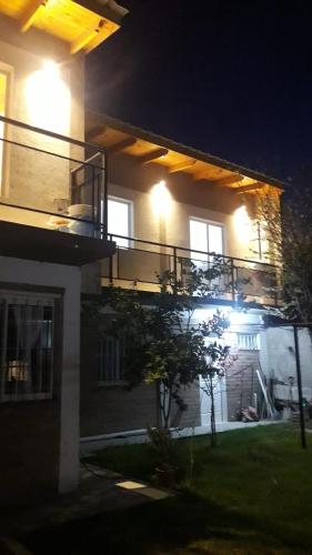 a house lit up at night with a balcony at ballena franca in Puerto Madryn