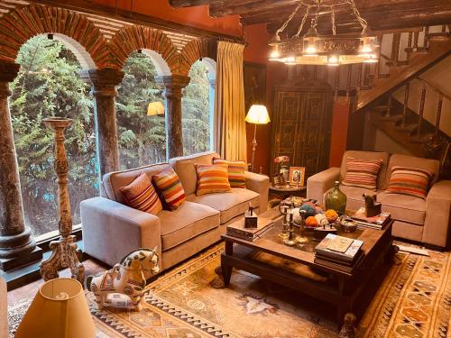 a living room with a couch and a table at Inka Tambo Hacienda in Cusco