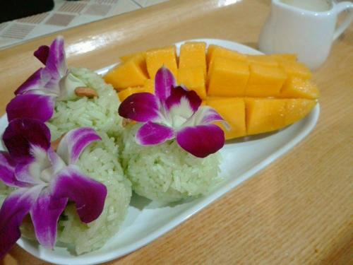 a plate of sushi with rice and flowers on a table at Kohjum Seafront Resort in Ko Jum