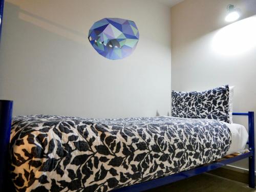 a bedroom with a bed and a blue bench at Boulevard Waters in Taupo