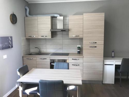 a kitchen with a table and chairs in a room at White House 4 in Brescia