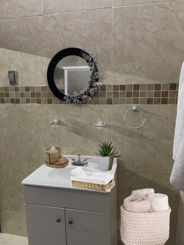 a bathroom with a sink and a mirror at La casa del colibrí in Campeche