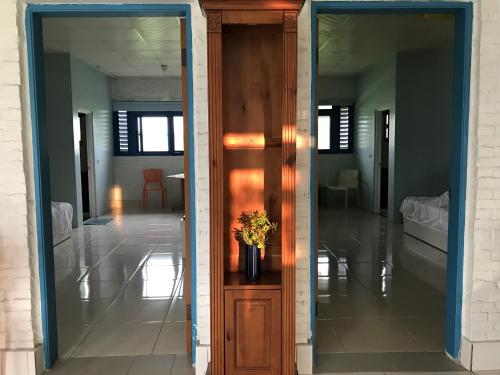 a hallway with a door with a vase with a plant at 布袋愛琴海Aegean Sea B&B Budai in Budai