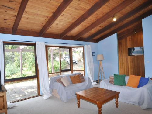 a living room with a couch and a table at Beechwood Surf Side in Inverloch