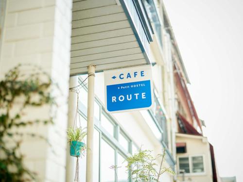 a sign on the side of a building that reads cafe centric at ROUTE - Cafe and Petit Hostel in Nagasaki