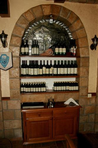 a room with a wall filled with bottles of wine at Motel Krstac in Mojkovac