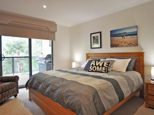 a bedroom with a large bed and a window at THE ULTIMATE CHILL PILL - FREE WIFI & FOXTEL in Inverloch