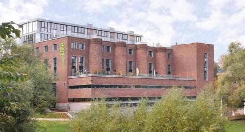 a large red brick building with a large at Awardwinning penthouse, Oslo city / Grünerløkka in Oslo
