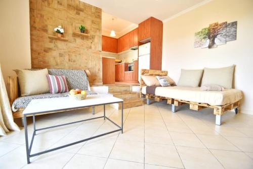 a living room with a couch and a table at Konomi Residence in Karavadhos