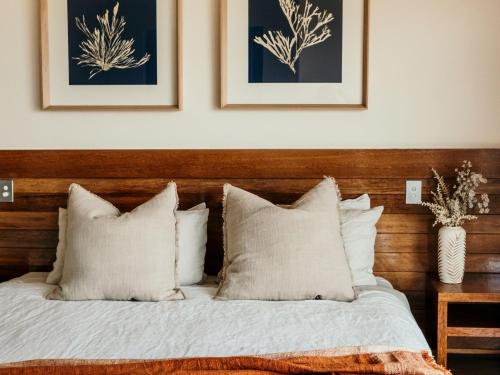 a bed with white sheets and pillows in a bedroom at Hearns Beachside Villa 8 in Port Fairy