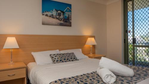 a hotel room with two beds and a window at Montana Palms Resort in Gold Coast