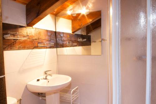 a bathroom with a sink and a shower at La Caseta de Sastre in Eriste