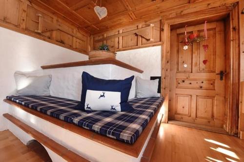 a bedroom with a bed in a wooden cabin at Haus Saler in Gaschurn