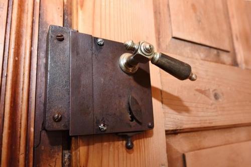a wooden door with a bronze door knocker on it at Haus Saler in Gaschurn