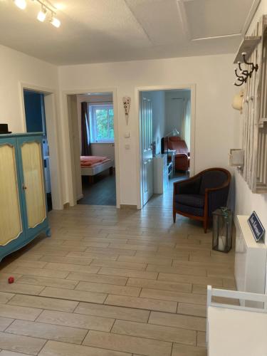 a living room with a couch and a chair at Zum Eulennest in Rantrum