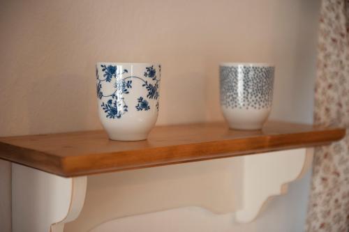 two blue and white vases sitting on a shelf at Chalupa Barborka in Mezimesti