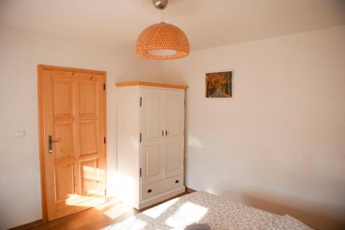 a bedroom with a bed and an open door at Chalupa Barborka in Mezimesti