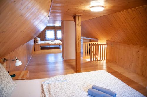 a room with a bed and a wooden ceiling at Chalupa Barborka in Mezimesti