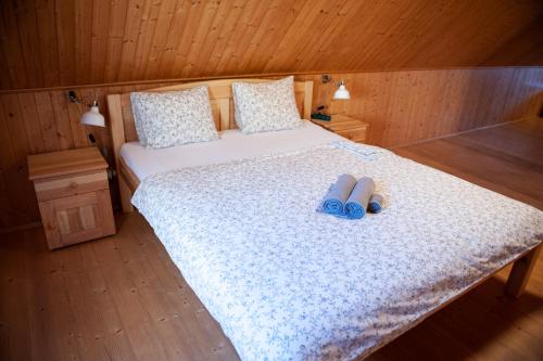 a bedroom with a bed with two slippers on it at Chalupa Barborka in Mezimesti