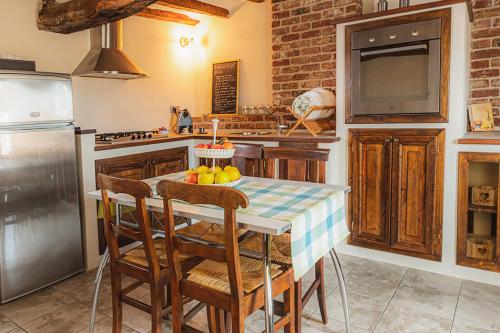 a kitchen with a table with a cake on it at Il Giardino sul Tetto B&B in Guarene