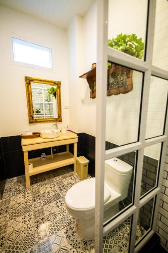 a bathroom with a toilet and a sink at Baroque Boutique Resort in Ranong