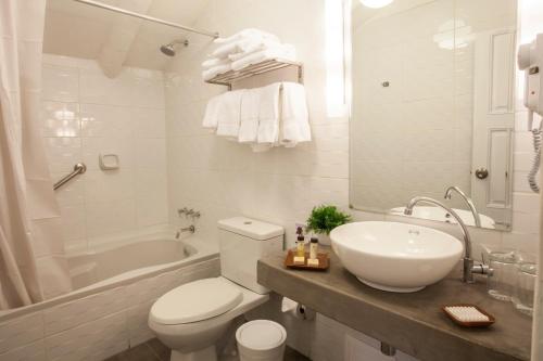a bathroom with a toilet and a sink and a tub at Tierra Viva Cusco San Blas in Cusco