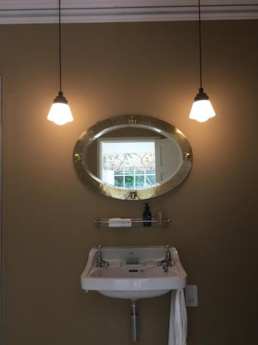 a bathroom with a sink and a mirror at Noyadd Trefawr in Cardigan